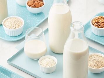 Image of milk in glass containers, bowls of rice and nuts